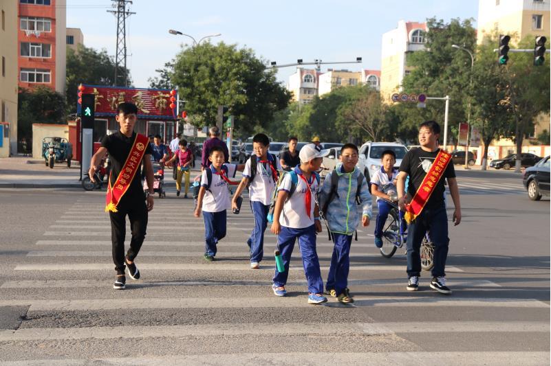 志愿者引導學生過馬路
